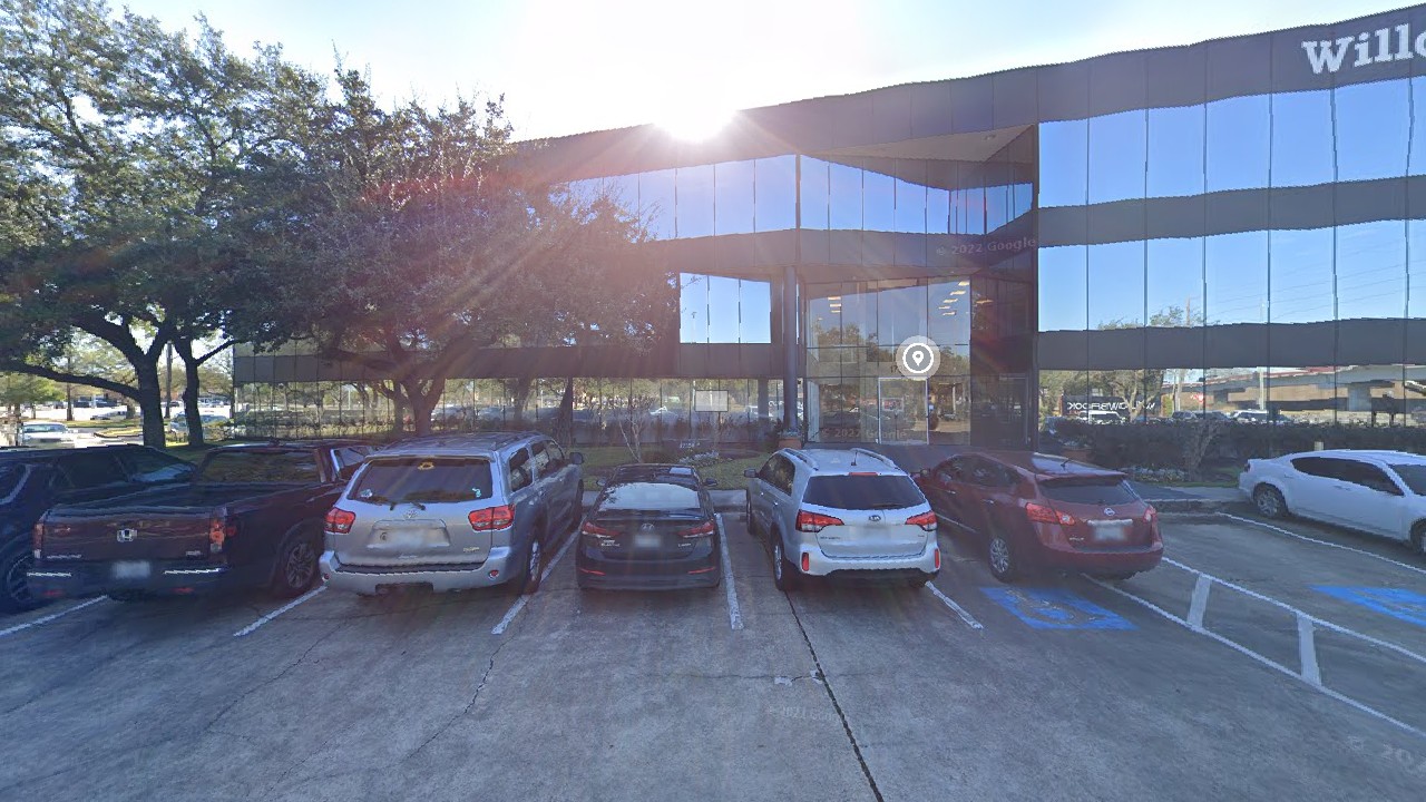 Street view of Decision Science Corp Houston office - glass facade office building on State Hwy 249